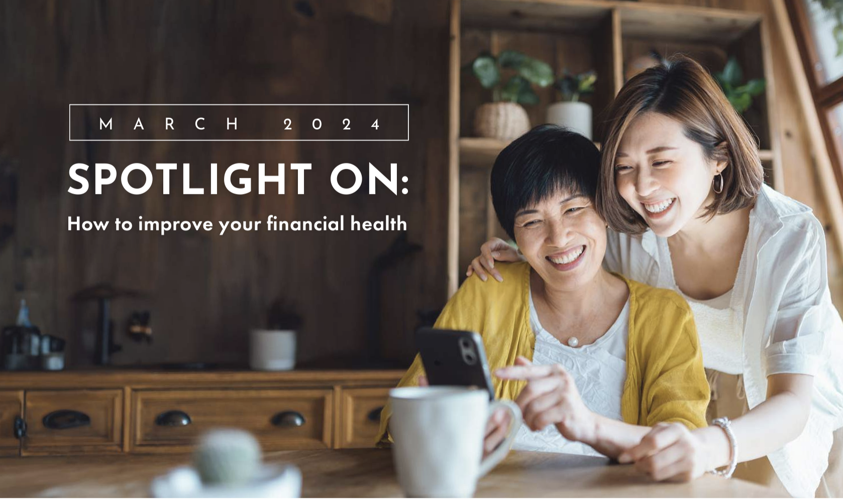 March 2024 - Spotlight on: how to improve your financial health. Happy family looking at phone. mother daughter